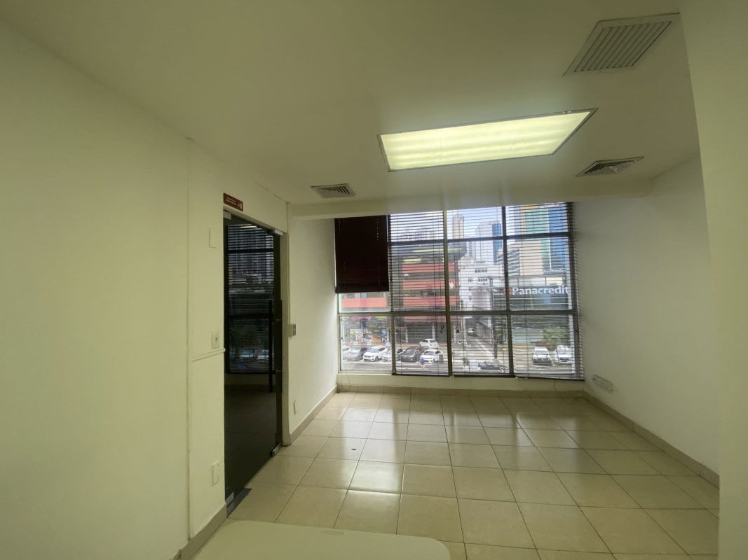 Bright empty office with large windows and ceramic tile floors facing Calle 50 Panama City