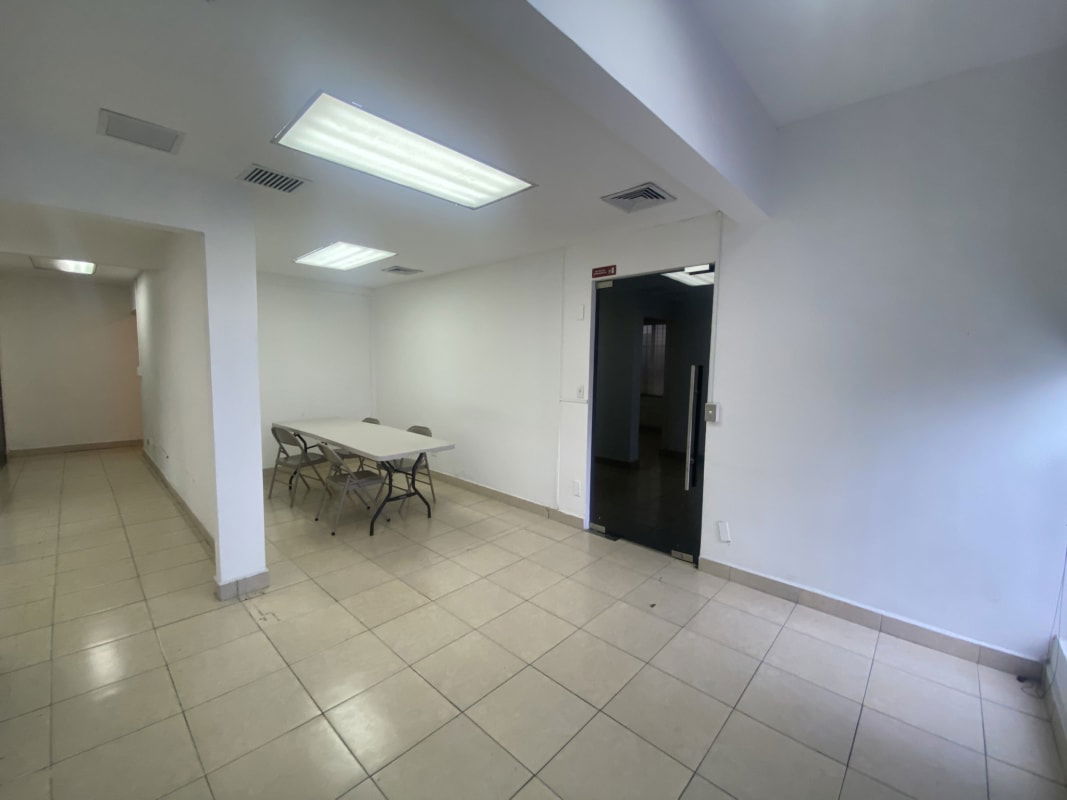Open office with folding table and chairs, fluorescent lights, tile floors in Bella Vista Tower Panama
