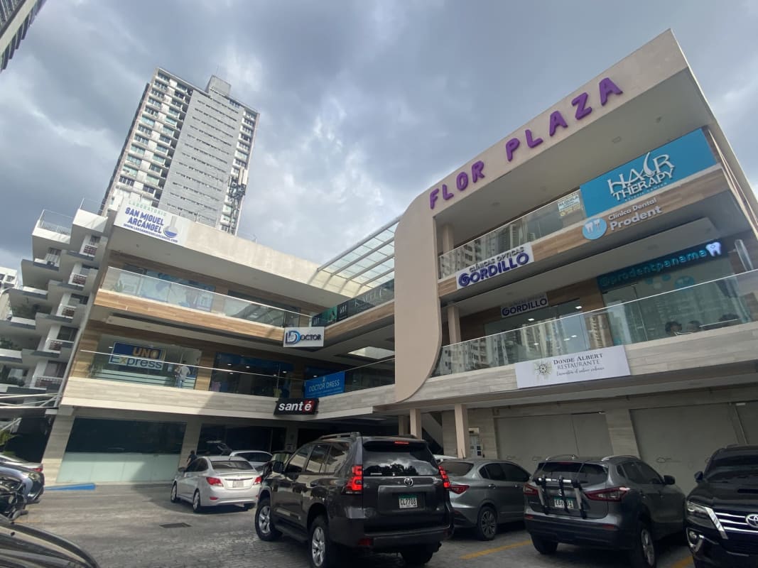 Modern multi-story commercial plaza with storefronts and ample parking on Calle 50, Bella Vista, Panama City