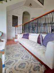 Bright modern kitchen with granite backsplash and stainless steel appliances in Altos del María Panama