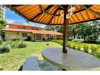 Rustic style kitchen with dark wood cabinets tiled countertops window Playa Malibú Nueva Gorgona