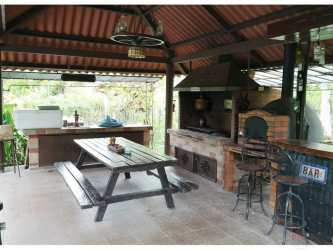 Covered outdoor kitchen and BBQ area near pool on estate property Nueva Gorgona Chame Panama