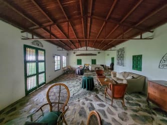 Wraparound terrace on rustic cabin surrounded by reforested mountain landscape for sale Panama