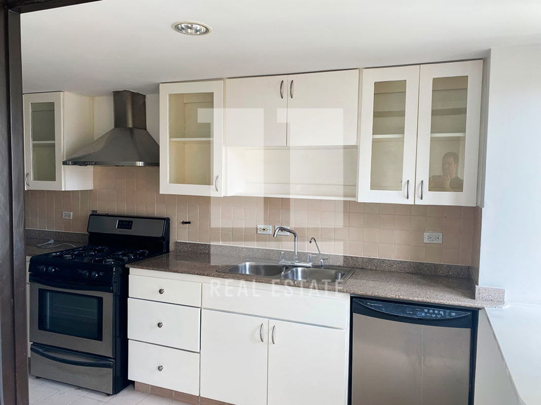 Modern kitchen with granite countertop and stainless appliances in Casco Viejo colonial apartment Panama