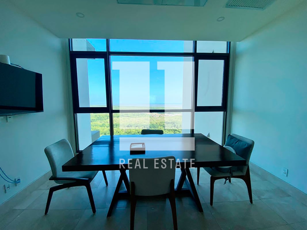 Dining area with panoramic window views of golf course and ocean, modern decor in PH Albatross Santa Maria Panama