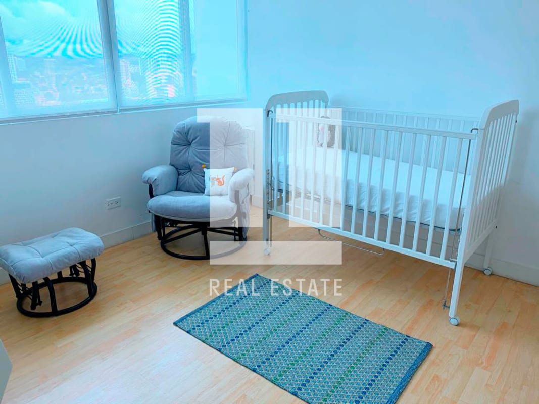 Semi-open kitchen with granite bar and fridge in Foresta Tower apartment Panama