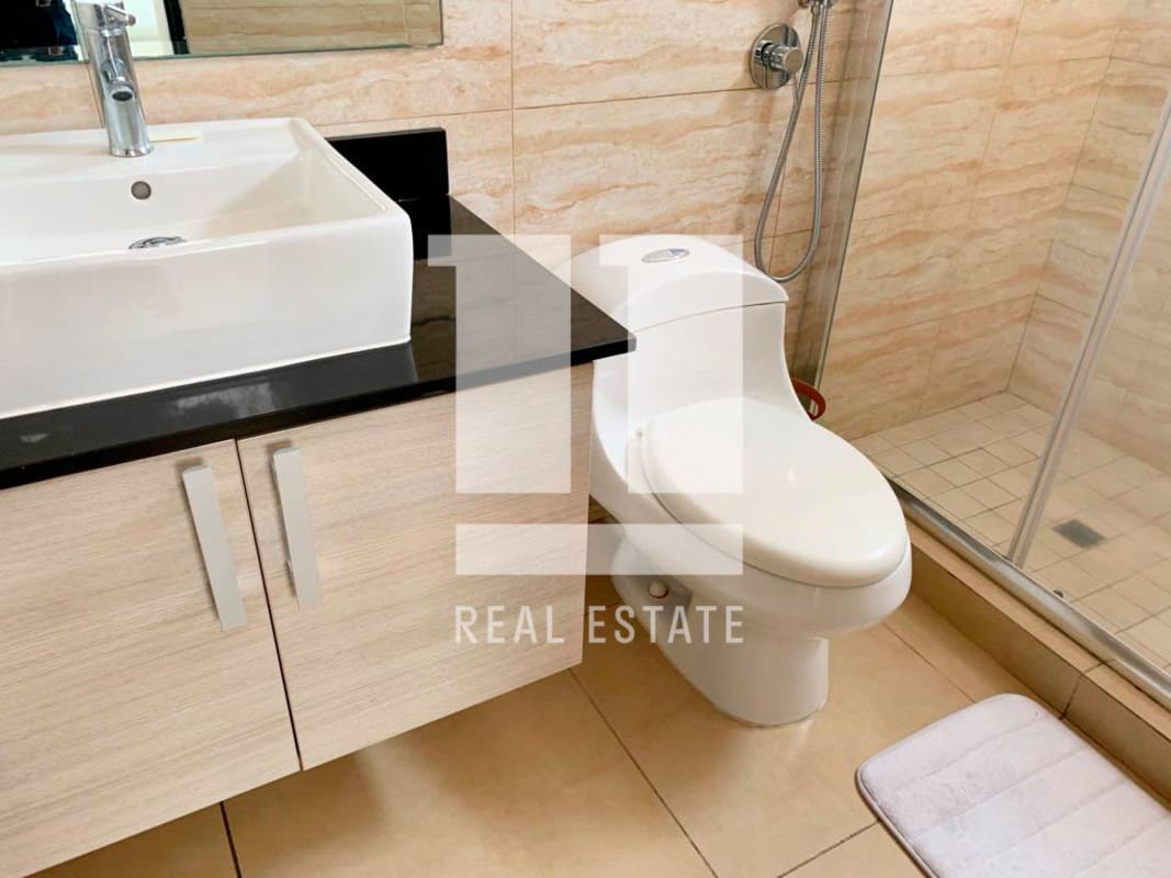 Bright bedroom with wood floors and large windows at Foresta Tower Panama apartment