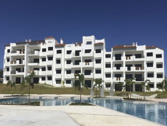 Luxury beachfront condominium swimming pool area with palm trees in Playa del Sol San Carlos