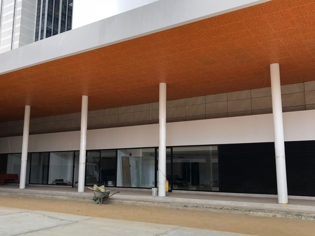 Facade with geometric design, reflective glass and modern signage Plaza Nodo54 Panama