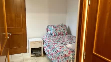 Bedroom with tile floor and garden lake view balcony at vacation rental Buenaventura Panama