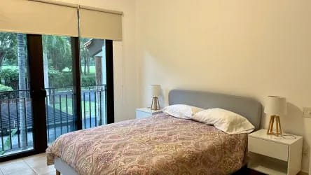 Bedroom with large glass doors opening to private balcony at Buenaventura beach condo Panama