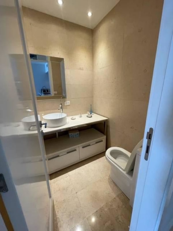 Large master bedroom with floor-to-ceiling windows and ocean skyline view in PH White Tower Panama City