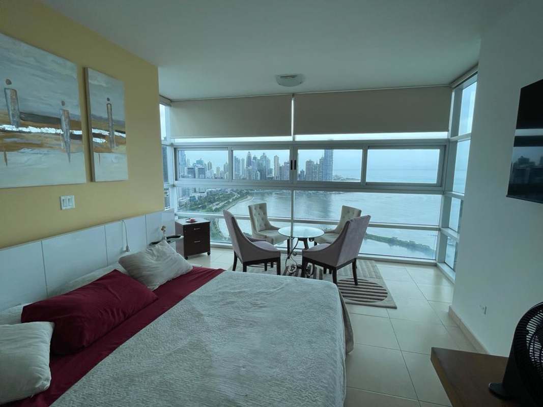 Open plan kitchen with granite countertops and stainless appliances in furnished apartment PH White Tower Panama