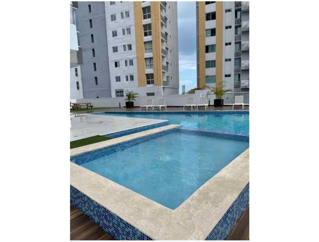 Family-friendly pool area lounge chairs potted plants condo Park Point Panama