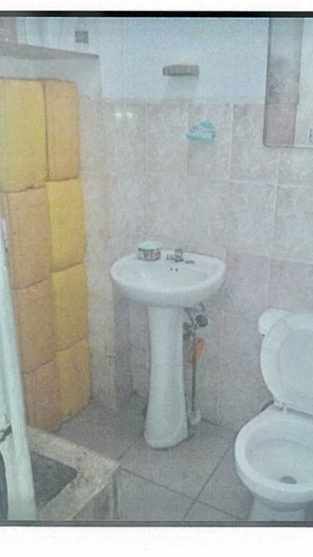 Small bathroom with pedestal sink and toilet inside commercial property in Gran Estación San Miguelito