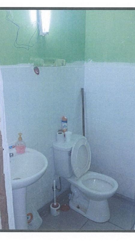 Bathroom inside retail unit at Gran Estación San Miguelito Panama with pedestal sink and toilet