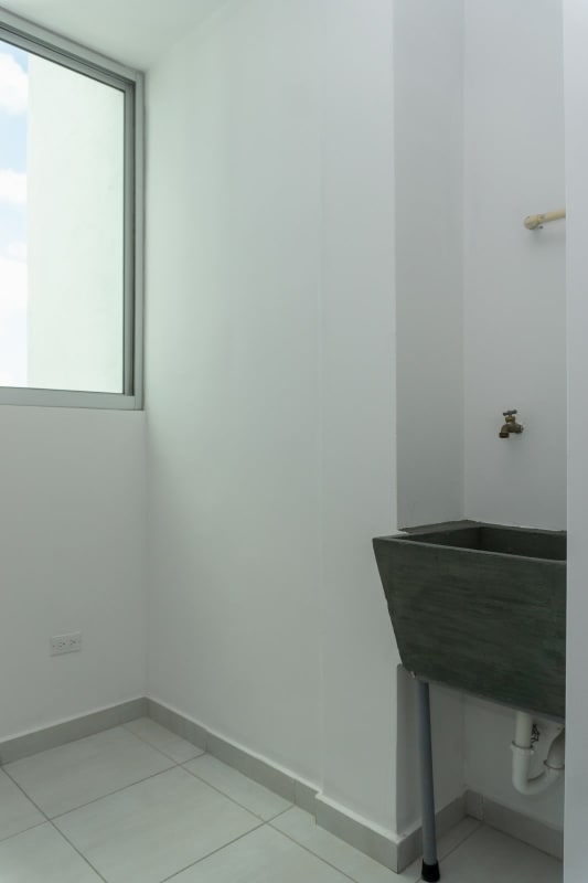 Bedroom with floor-to-ceiling windows, built-in closet and skyline view in PH Trinity