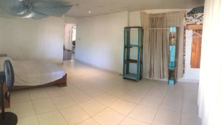 Bright bedroom with large window and tile floor David Panama home