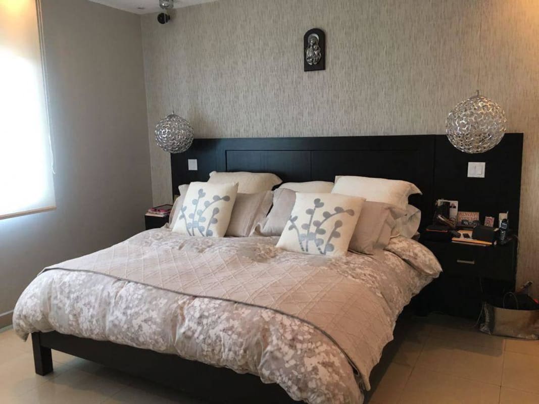 Spacious master bedroom with accent lighting neutral décor PH Zeus Panama City
