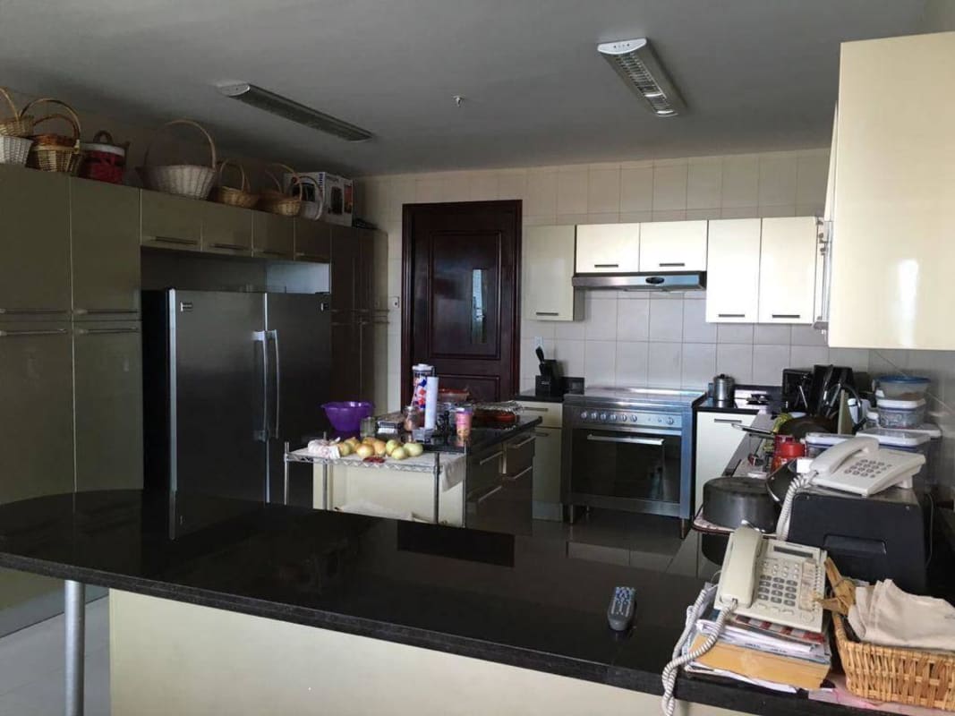 Contemporary kitchen with granite countertops, island, and stainless appliances in PH Zeus Panama