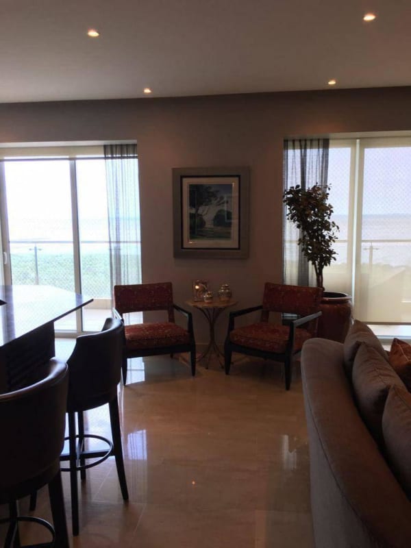 Modern living room with sliding doors opening to balcony ocean view PH Zeus Costa del Este Panama