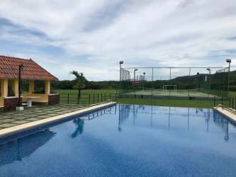 Large open grassy lots with scattered mature trees in residential complex Chame Panama