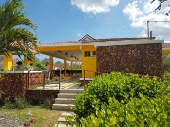 Mediterranean architecture pool area with pergola and gardens in Chame Panama residential complex