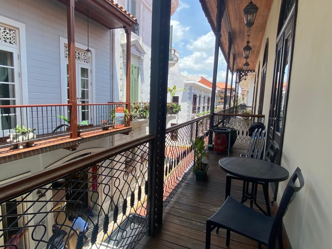 Office area with large window, brown curtains, colonial apartment Casco Viejo Panama