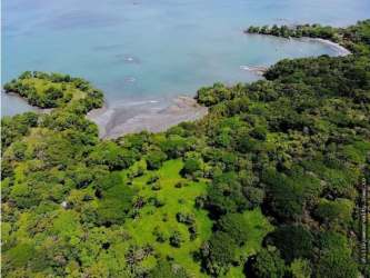 Aerial view of pristine beaches dense jungle and coastline Isla Brava Panama