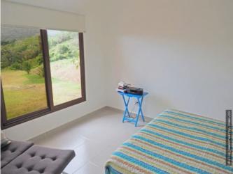 Modern bedroom with minimalist decor, walk-in closet, AC and mountain view window in Trinity Hills Valley Campana
