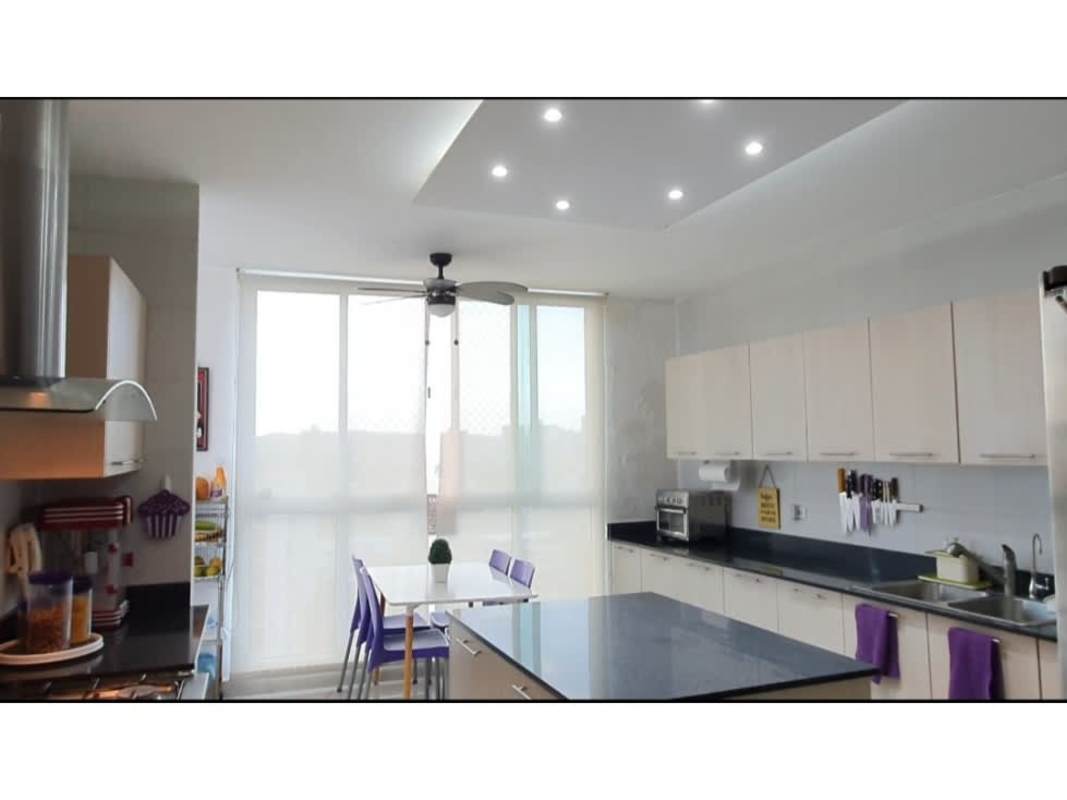 Bright apartment kitchen with island, dining area, modern appliances at Highland View Panama