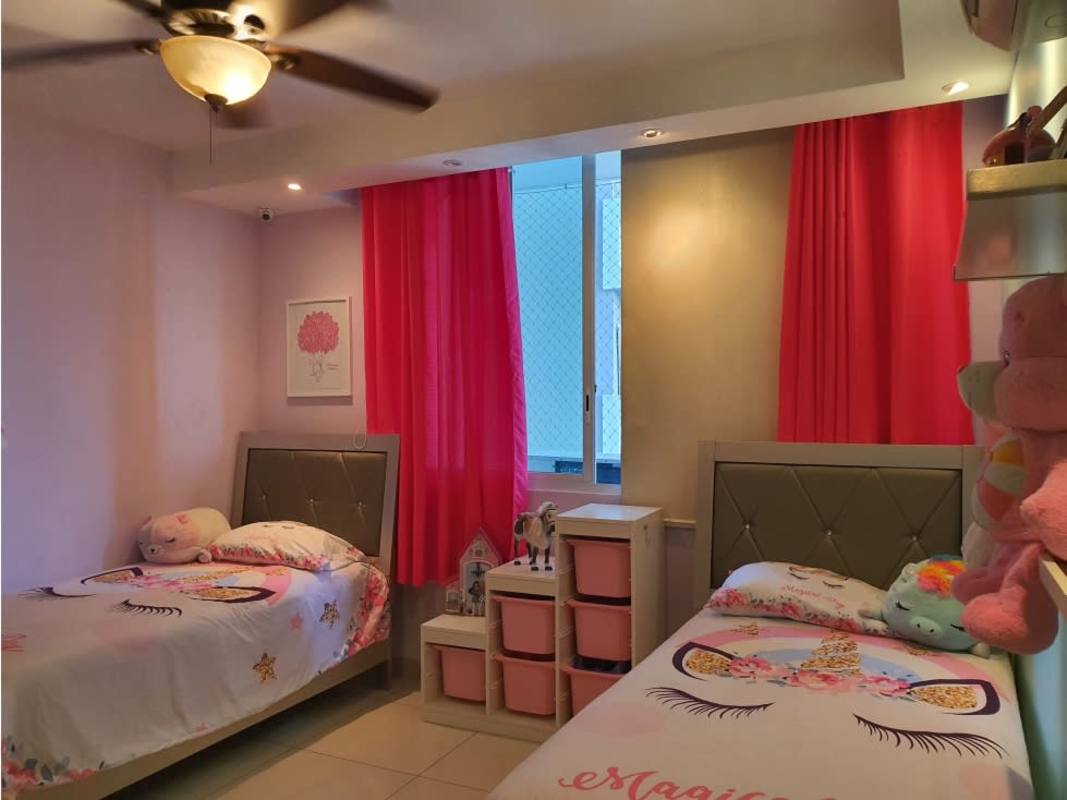 Bedroom with fairy lights, AC, bookshelf, TV console at Highland View Panama