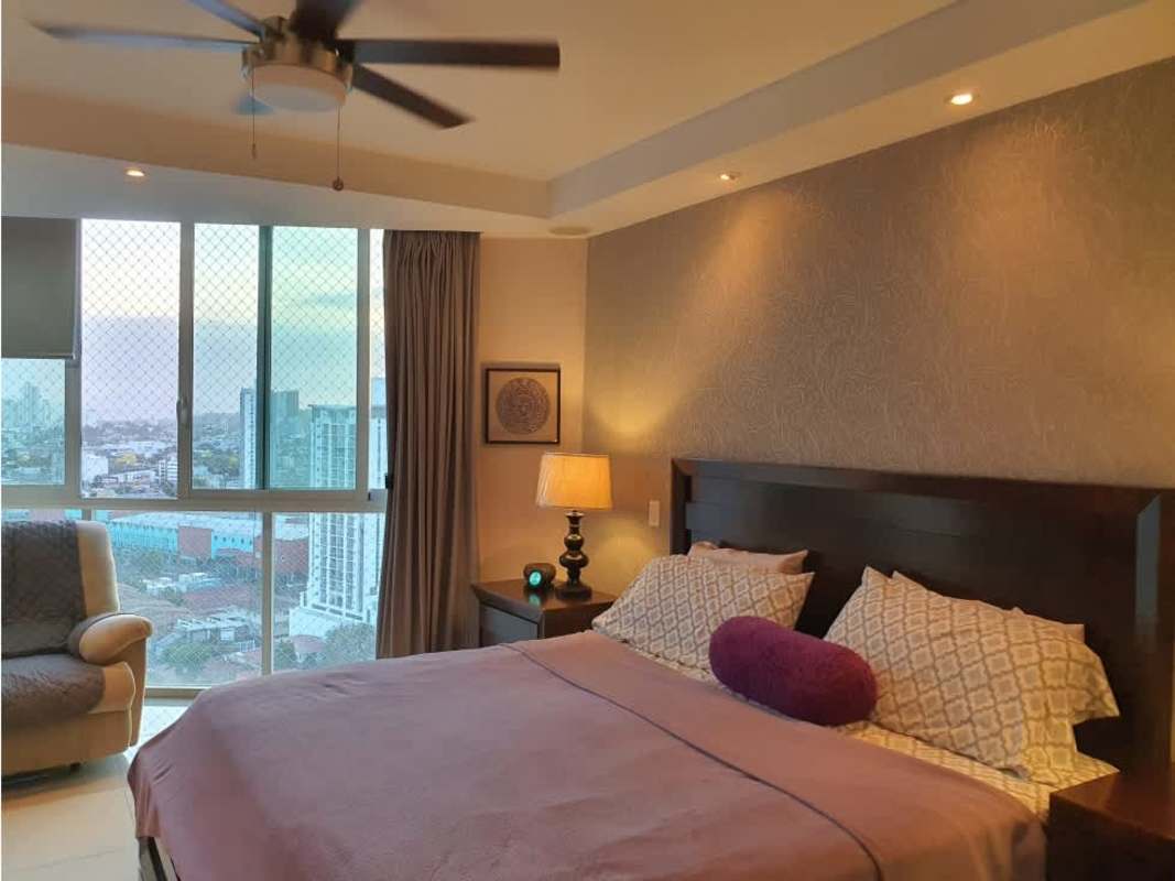 Master bedroom with large windows, king bed, ceiling fan, contemporary decor at Highland View Panama
