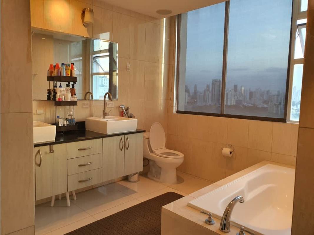 Bathroom with double sinks, large mirror, bathtub, city view in Highland View Panama condo