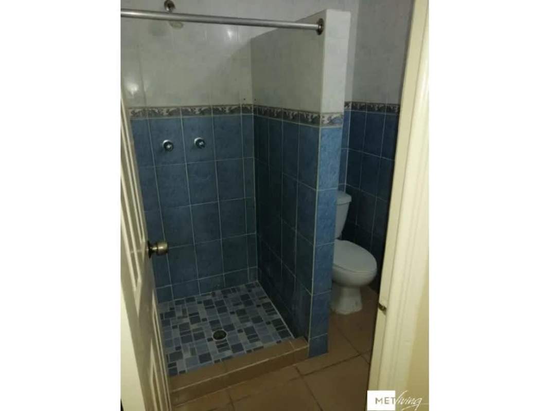 Exterior multi-story PH Pueblito Lindo building pink facade balconies security bars Panama City