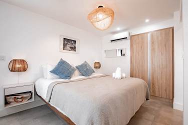 Spacious bedroom with woven light fixture and ocean-inspired decor in Playa Venao Panama