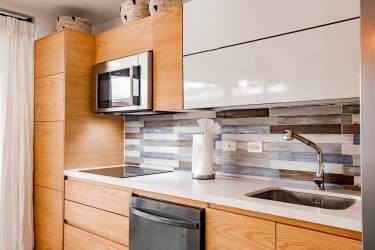 Resort-style swimming pool with palm trees, thatched lounge area in Blue Venao Playa Venao Panama