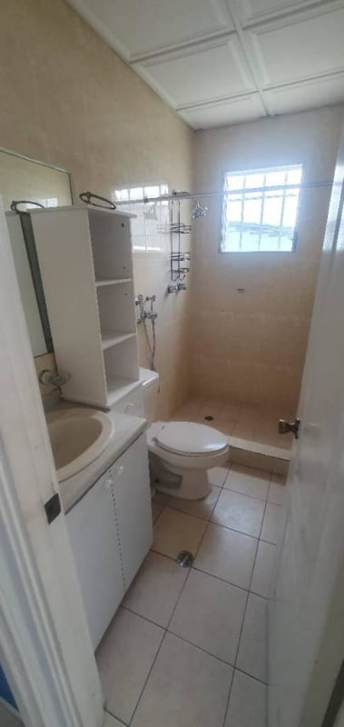 Small bathroom with beige tiles walk-in shower and vanity Villa Zaita Panama