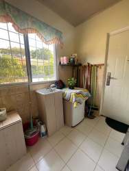 Laundry area in Chame house with washer, cabinets and large window