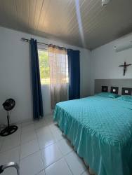 Open dining and kitchen space with white tiles, air conditioning, natural light in Chame Panama