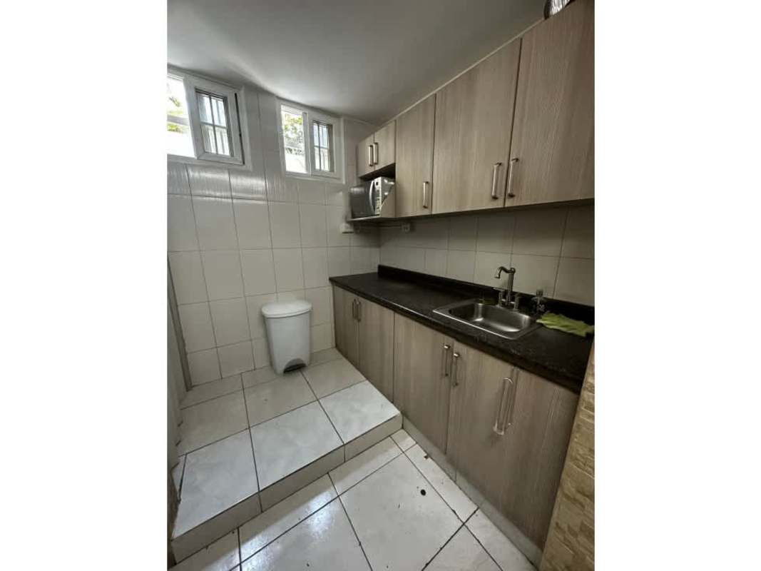 Conference room with large wooden table, whiteboard, overhead lighting in Plaza 50 Tower Panama