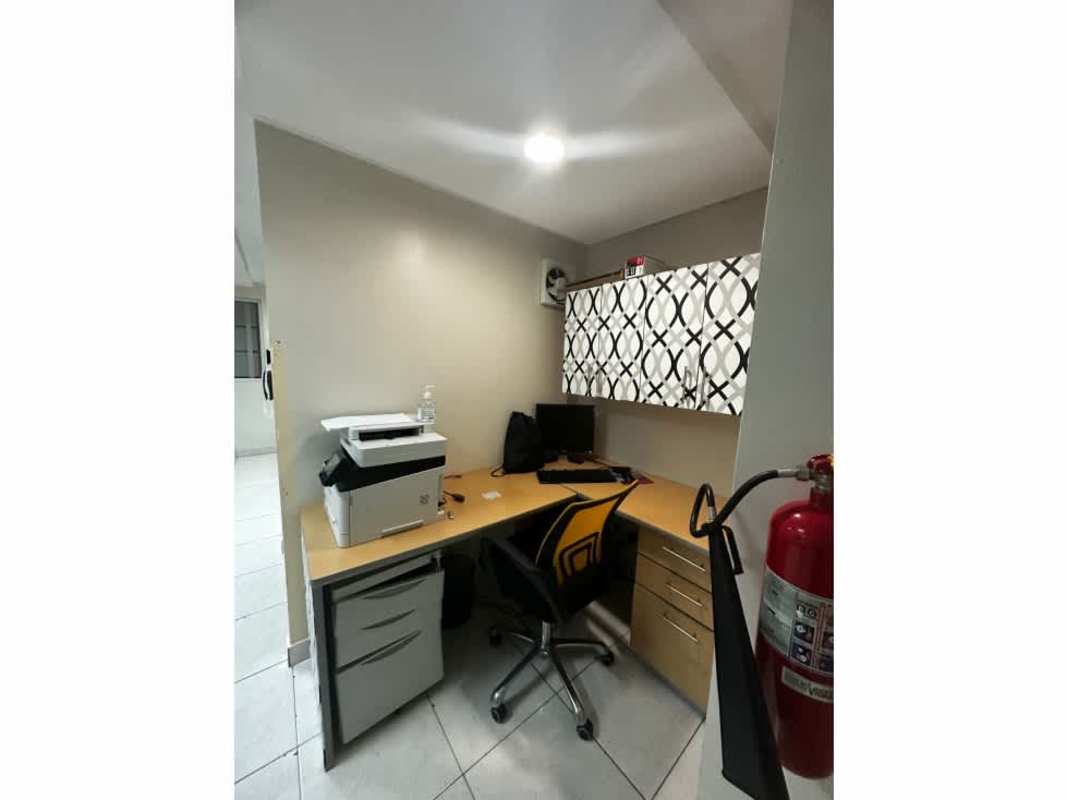 Modern bathroom with dark tiles, round mirror, sink and toilet in Plaza 50 Tower office Panama