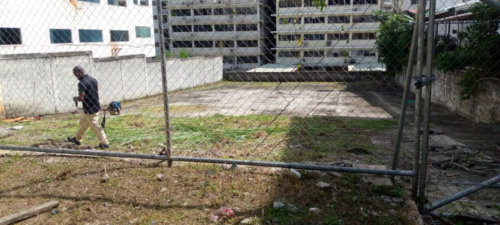 Vacant urban lot corner location with fencing and partial concrete surface for sale Panama City
