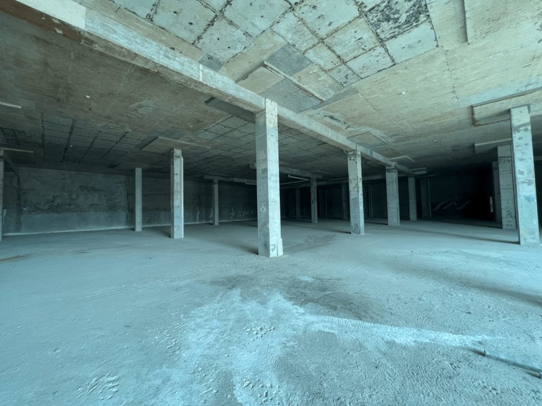 Shopping mall corridor with escalators retail storefronts bright lights at Paseo Albrook Panama City