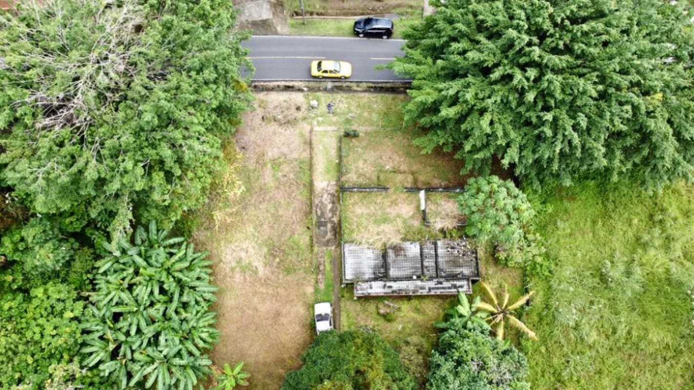 Wide aerial view of big tropical property with trees and abandoned buildings Panama