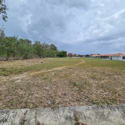 Open plot of land near houses under cloudy sky in Punta Chame residential Panama