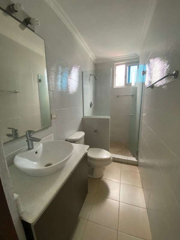 Modern bathroom with vessel sink and glass shower PH Park City Panama City