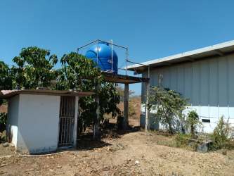 Metal platform water tank and storage sheds on commercial lot Los Santos Panama