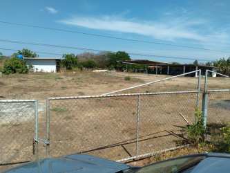 Urban roadside with access gate, paved road on property frontage El Espinal Panama