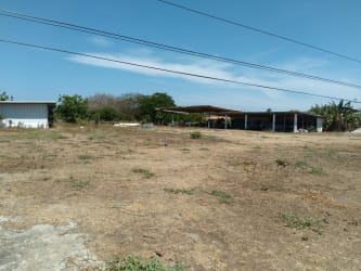White house with red roof and covered patio on commercial lot in El Espinal Panama